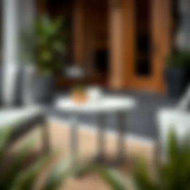 Chic Round Metal End Table with Lounge Chairs Stylish round metal end table paired with outdoor lounge chairs